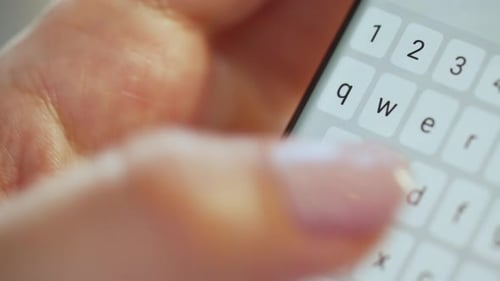 Hands Typing Text on Smartphone Close-up