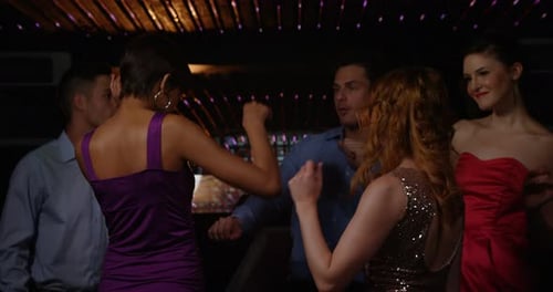 Group of friends dancing in pub