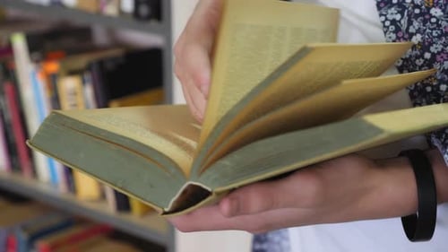 Hand Turning Pages of a Book, Close-up