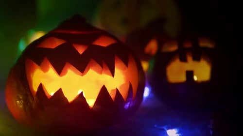 Smoke Is Blowing Off Halloween Pumpkins Standing at the Wooden Table
