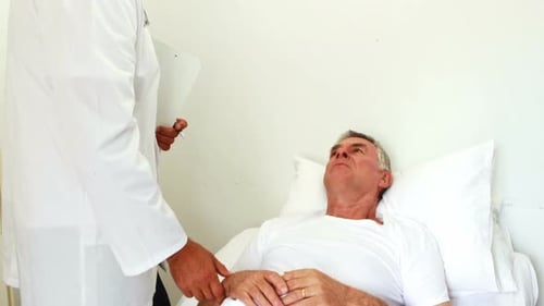 Doctor Checks on Patient in Hospital Bed