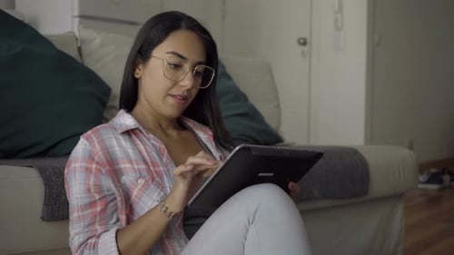 Young Adult Woman Using Tablet Indoors at Home