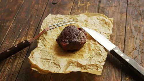 Fork and Knife Near Roasted Meat