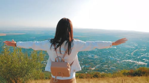 Successful Girl Hiker Open Arms in the Sky After Hiking To Mountain Top Summit Above the Clouds.