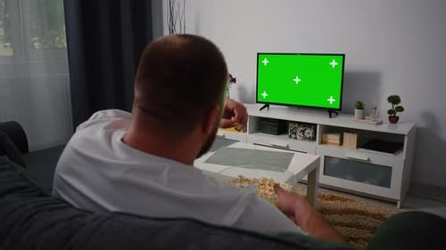 Man Watching Television with Green Screen Chroma Key