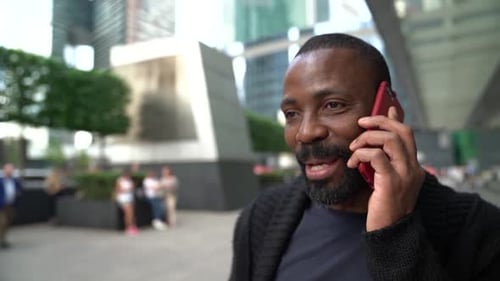 Portrait of a Cheerful and Smiling African American Man Located on a City Street in the Afternoon