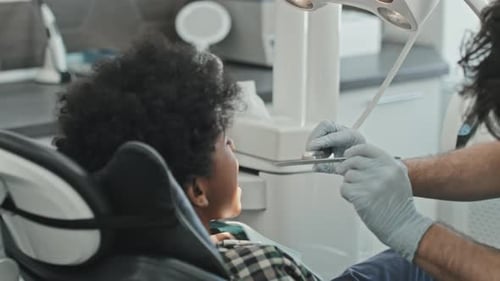 Medical Worker Examining a Child in Office