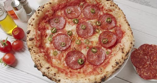 Hot Green Pepper Falls on the Pizza Ready Prepared with Pepperoni