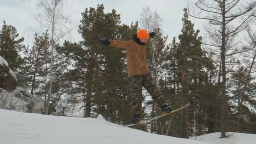 A Young Man Snowboarding