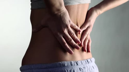 Woman experiencing back pain
