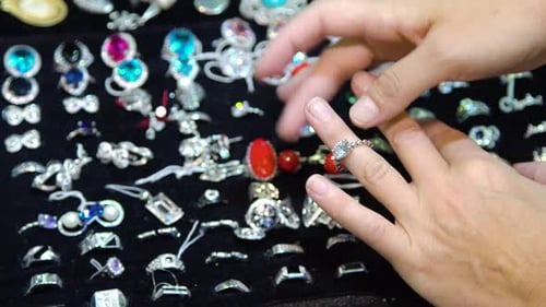 Woman Tries on Ring at Jewelry Display