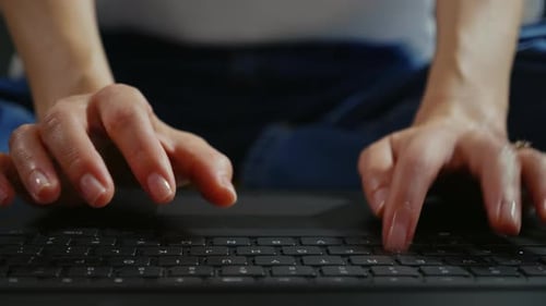 Woman's Hands Typing on a Laptop Keyboard