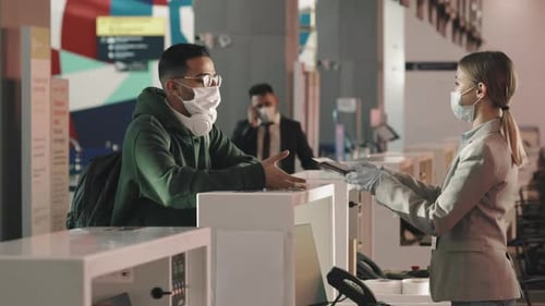 Travelers at Airport Check-In Counter Wearing Masks