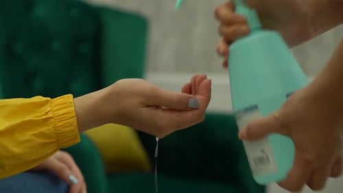 Hands of Woman Using Disinfectant