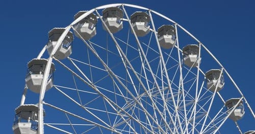 Ferris Wheel Rotates Against Blue Sky