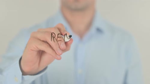 Man Writes Remote Monitoring on Clear Surface