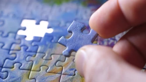 Finding the Solution Concept. Hand Matching Jigsaw Halves. Leisure Activity. Achieving the Goal Step