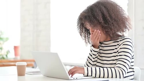 Woman Working At Computer Coughs Into Hand