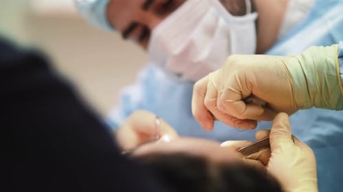 a man surgeon performs face and hands surgery close-up