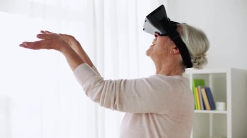 Senior Woman Interacting with Virtual Reality Headset Indoors