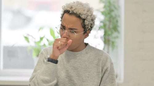 Woman Coughing Due to Illness Indoors