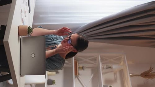 Young Woman Working From Home With Headache
