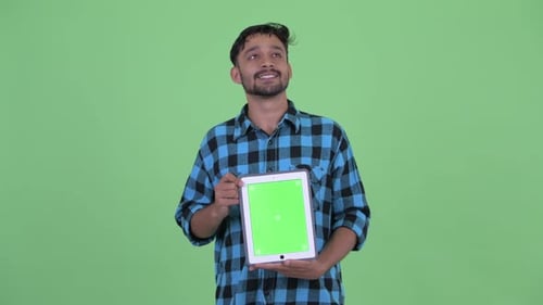 Young Adult Holding Tablet With Green Screen