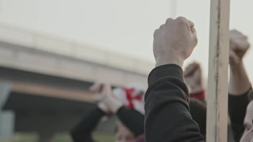 People Raising Fists with US Flag in City