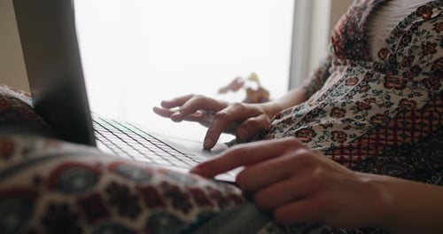 Woman Working at Laptop Indoors Daytime
