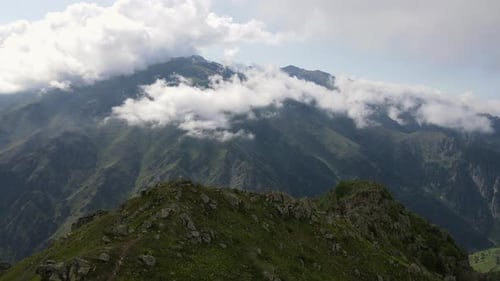 Majestic Mountains Covered in Clouds on a Sunny Day