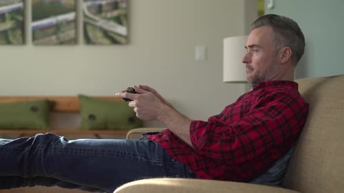 Man Relaxing at Home Playing Video Game