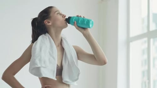 Woman Drinking Water After Workout