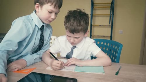 Children Studying with Tablet and Notebook Indoors