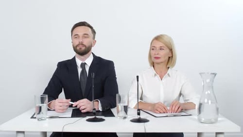 Man and Woman at Corporate Press Conference