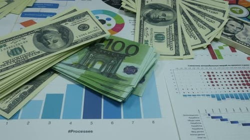 Stacks of Money with Pie Charts