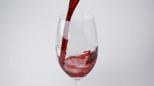 Pouring red wine into glass, Slow Motion