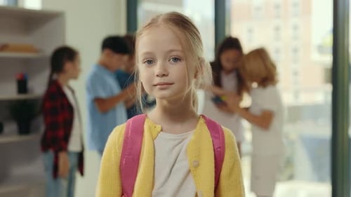 Portrait of the Smiled Girl Pupil on the School Break Standing in the Class Holding Backpack Looking