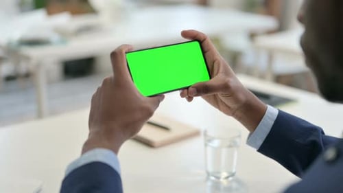 Businessman Watching Smartphone with Green Chroma Key Screen