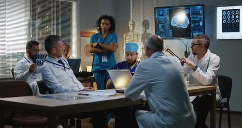 Medical Team Discussing Brain Scans in Conference Room