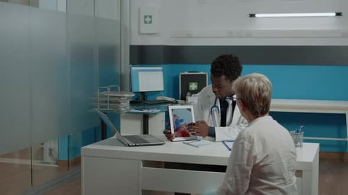Doctor Explains Heart Condition to Patient with Tablet