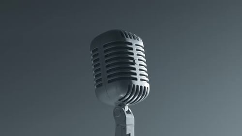 A desaturated vintage microphone on the stage. Closeup. Grey background. Old mic