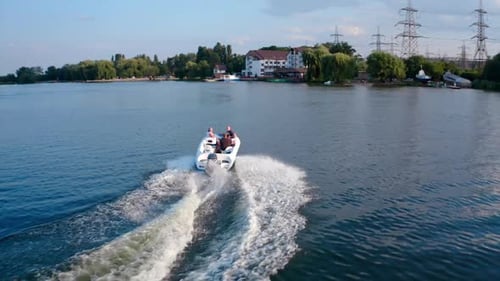 Drone footage of motor boat. Aerial view of boat floats alone on river