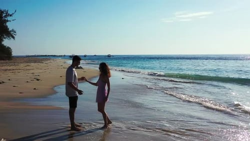 Man and woman tan on relaxing shore beach vacation by blue ocean and white sand background of Gili A