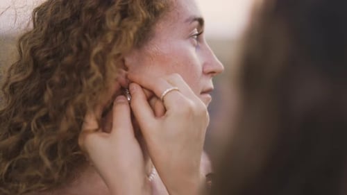Woman Getting Earring Put On in Golden Hour Light