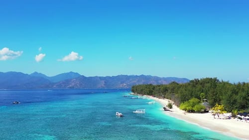 Paradise seashore of tropical island with white sandy beach washed by calm clear water of turquoise