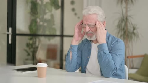 Senior Man Experiencing Headache Indoors