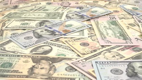 Pile of United States Currency Being Dropped