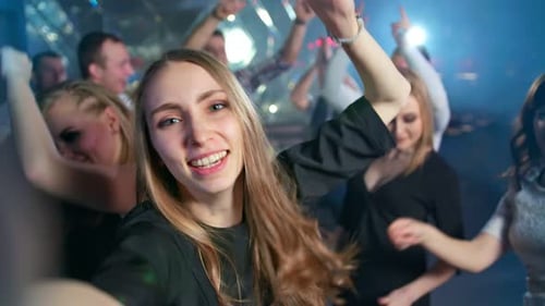 Pretty Woman is Taking a Selfie While Dancing at the Night Club