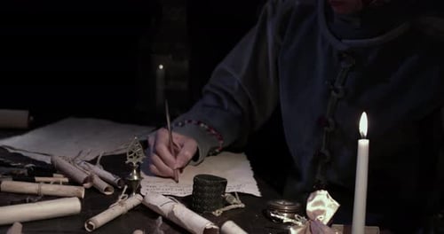 Person Writing with Quill by Candlelight