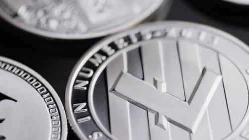 Rotating shot of Bitcoins (digital cryptocurrency) - BITCOIN LITECOIN